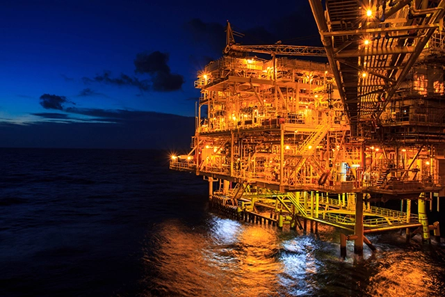 The large offshore oil rig at night with twilight background