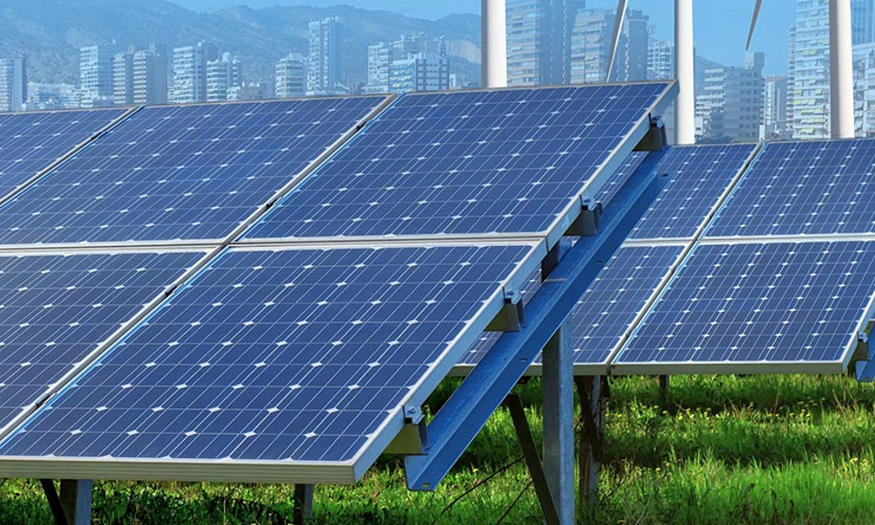 solar panels and wind turbines under blue sky and clouds with city on horizon