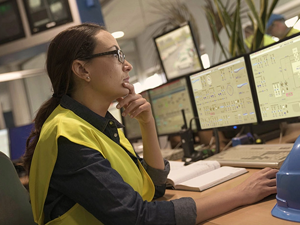 women engineer working in control room with HMI screens