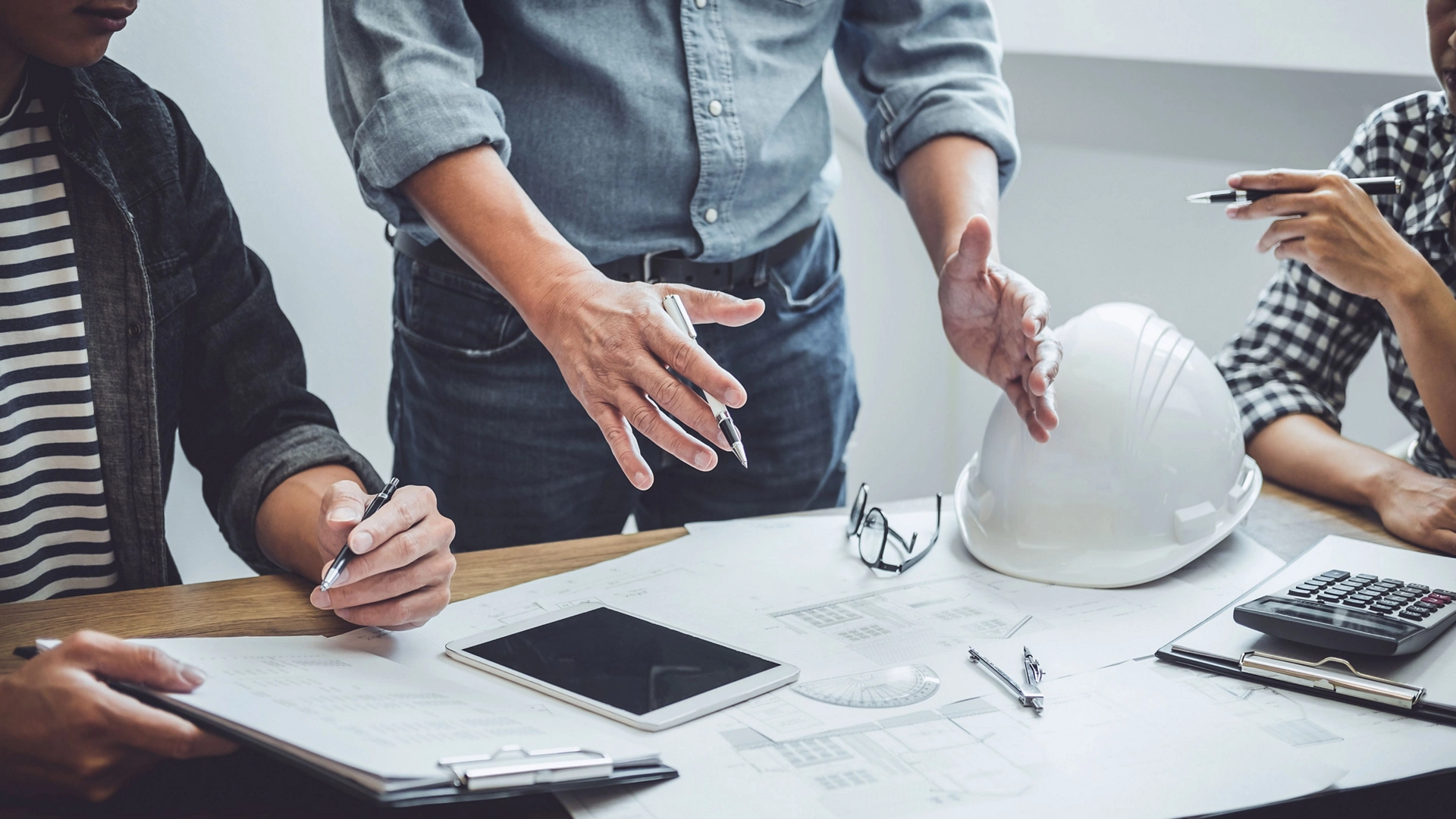 Construction and structure concept of Engineer or architect meeting for project working with partner and engineering tools on model building and blueprint in working site, contract for both companies.