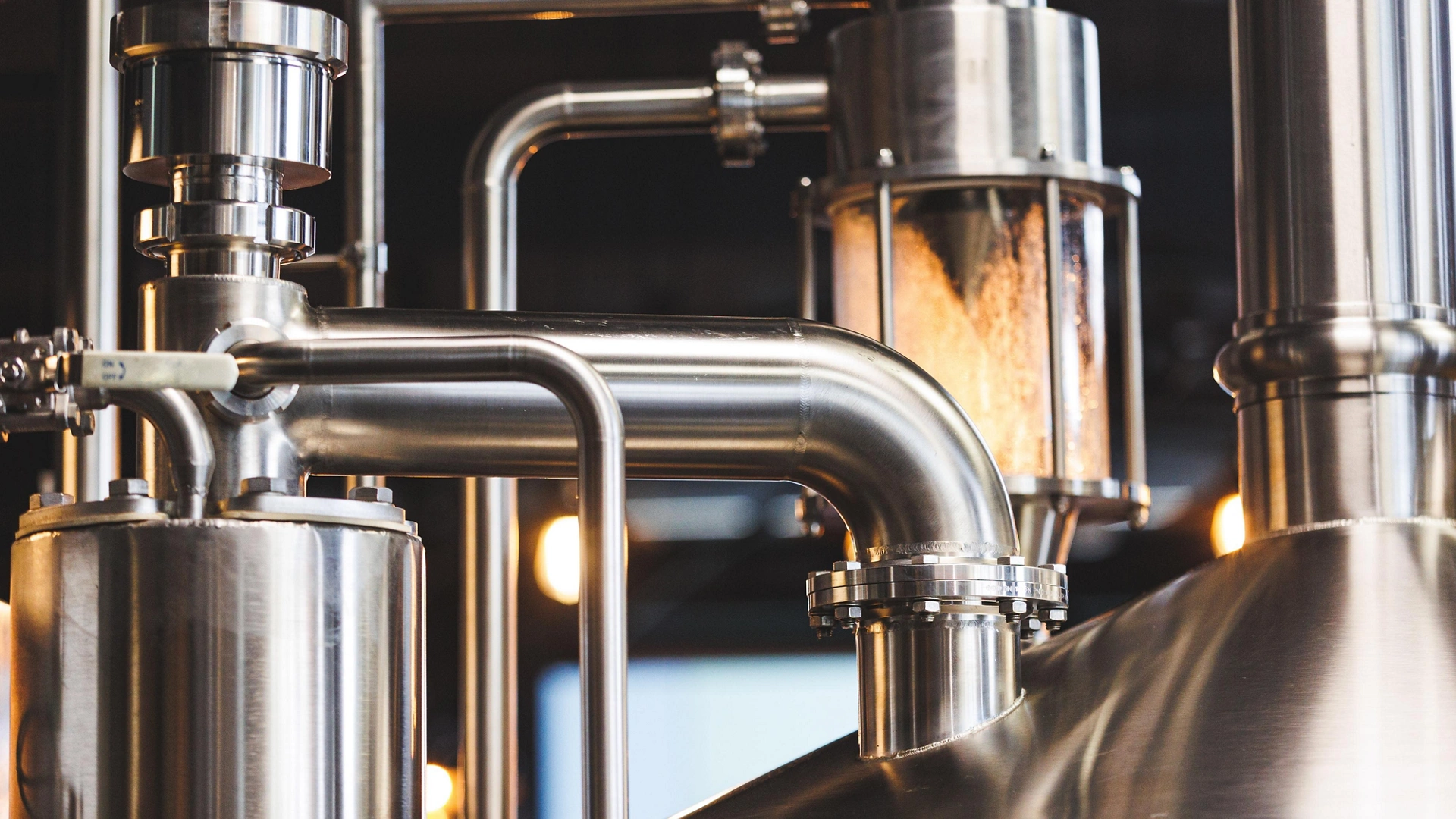 Beer brewing . Commercial brewing equipment close up shot. Industrial beer brewing stainless pipe