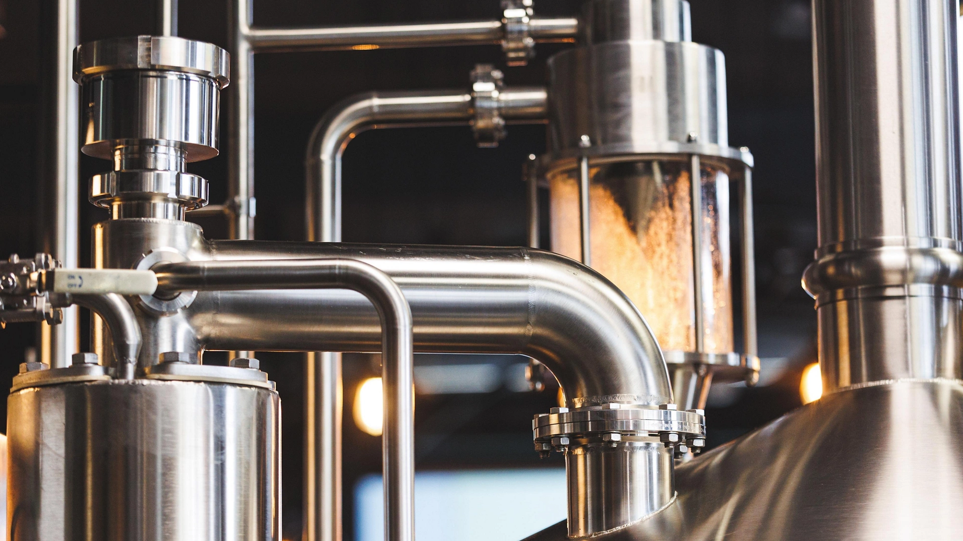 Beer brewing . Commercial brewing equipment close up shot. Industrial beer brewing stainless pipe