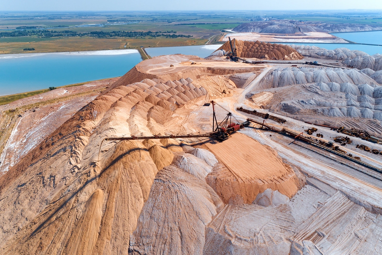 An industrial spreader in the process of work. The process of pouring rock piles.
