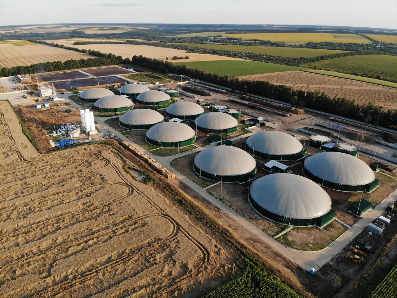 Modern bio comlex. Renewable energy from biomass. Innovative biogas plant among green nature.