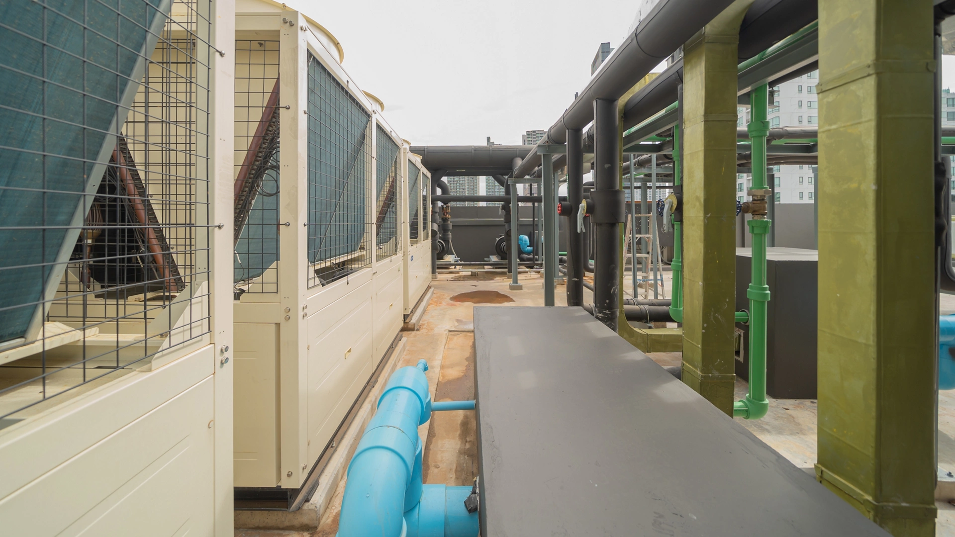 Chiller tower or cooling tower on rooftop of a office building in urban city. System work. Architecture machine. Condenser Water Supply and Condenser Water Return pipe lines. Ventilation compressor.