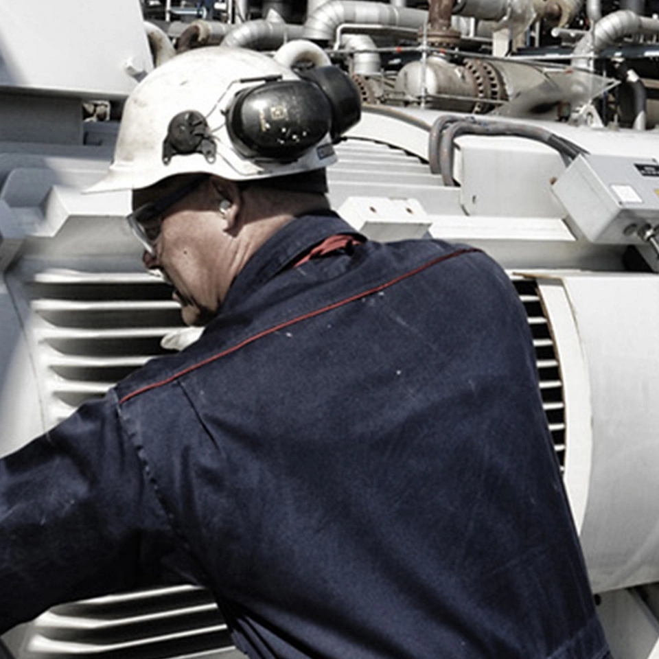industrial-workers-operating-large-machinery-in-an-outdoor-processing-facility-with-pipes-and-equipment-in-the-background