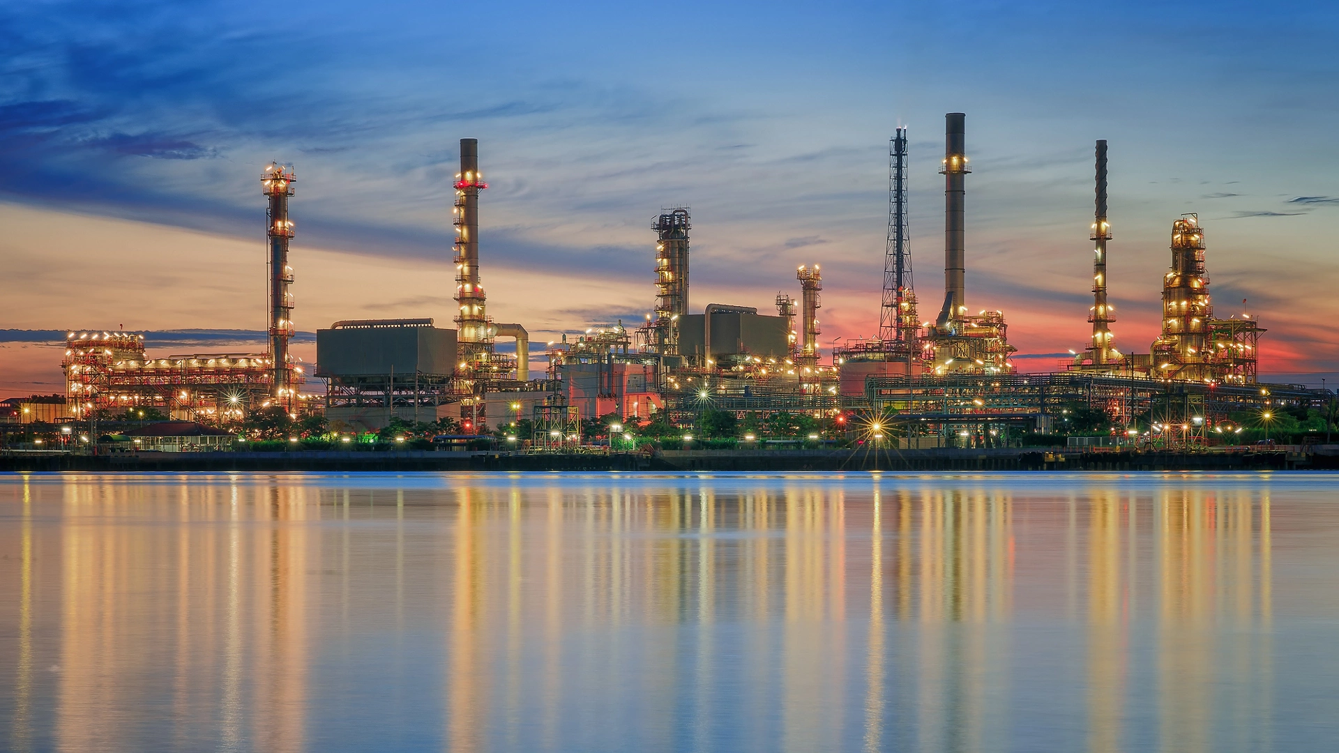petrochemical plant in night time with reflection over the river
