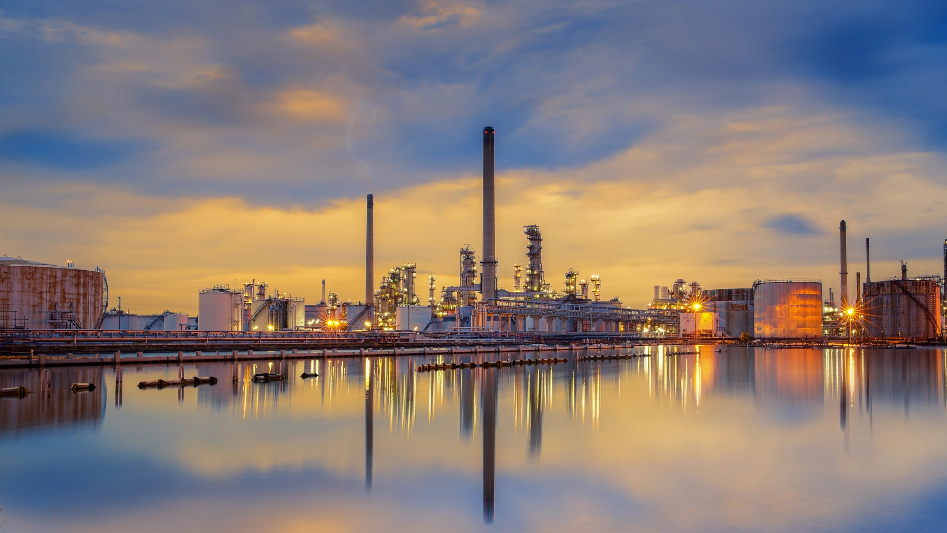 petrochemical plant in night time with reflection over the river