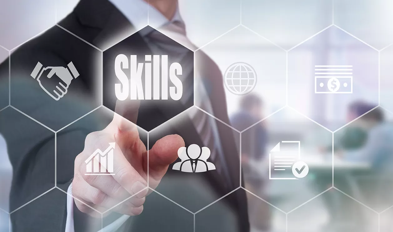 Businessman pressing an Skills concept button.
