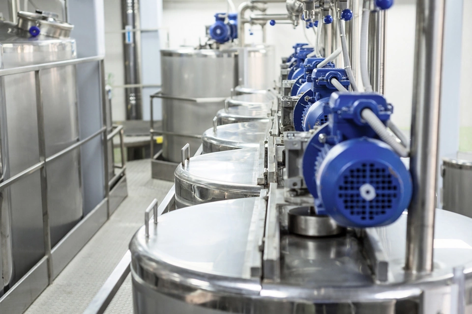 Electric motors on steel tanks for mixing liquids, modern production of alcoholic beverages. Food industry.