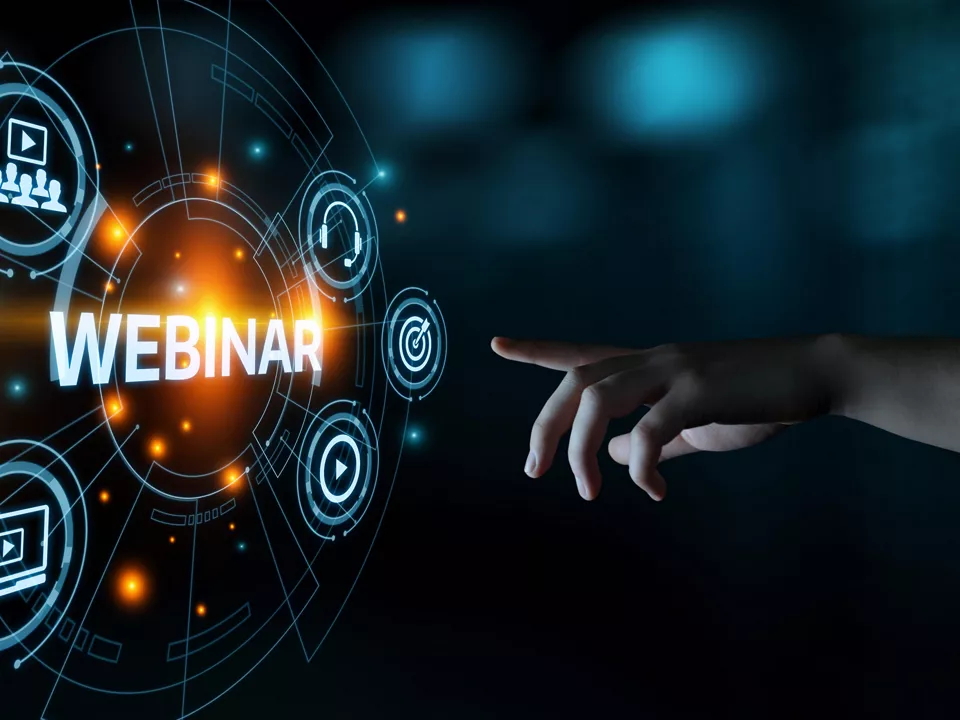 hand touching a hologram with webinar related icons on dark background